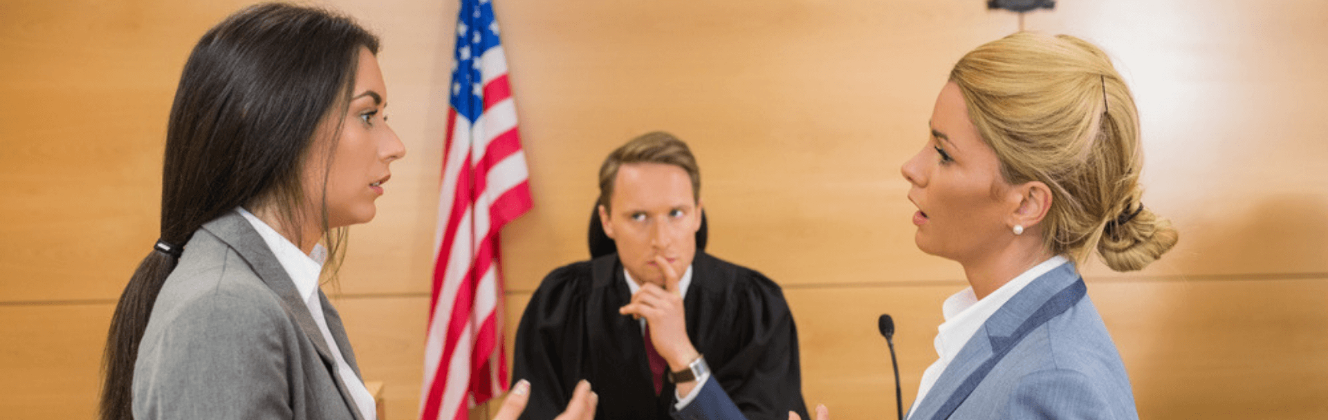 Two young students part taking in a moot court competition in front of a judge Two young students part taking in a moot court competition in front of a judge