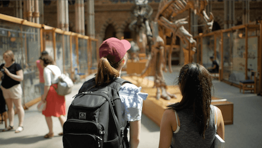 Two teen student girls looking at a dinosaur exhibit Two teen student girls looking at a dinosaur exhibit