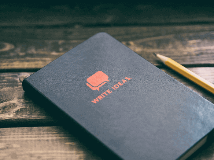 A notebook that says "write ideas" A notebook that says "write ideas"