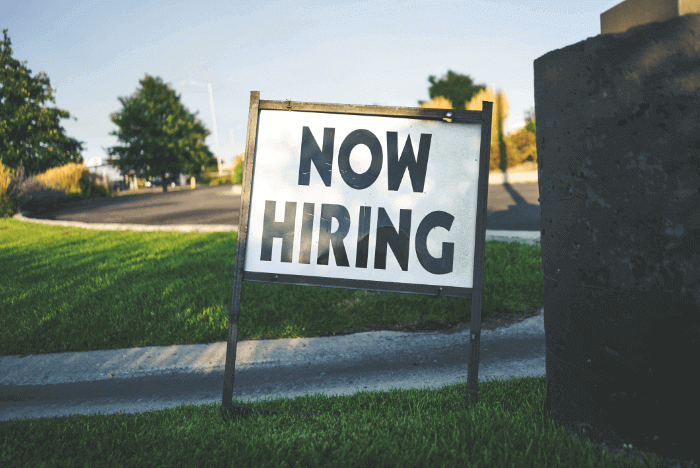 A "now hiring" sign for a job opportunity A "now hiring" sign for a job opportunity