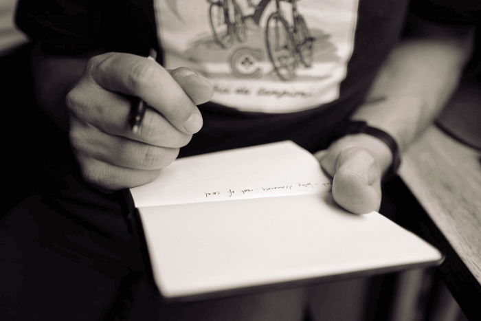 A teen taking poetry notes A teen taking poetry notes
