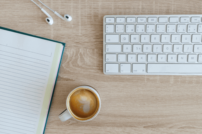 Learning how to write for a living with a coffee, notebook and keyboard Learning how to write for a living with a coffee, notebook and keyboard