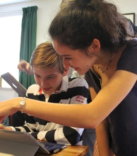 A tutor guiding a student during a summer school.