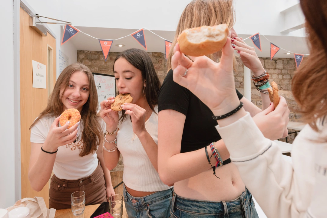 Group of students eating doughnuts